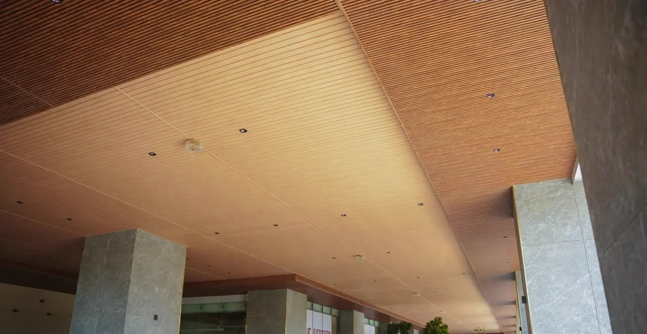 WPC linear timber ceiling running the length of a commercial entrance canopy in Hyderabad