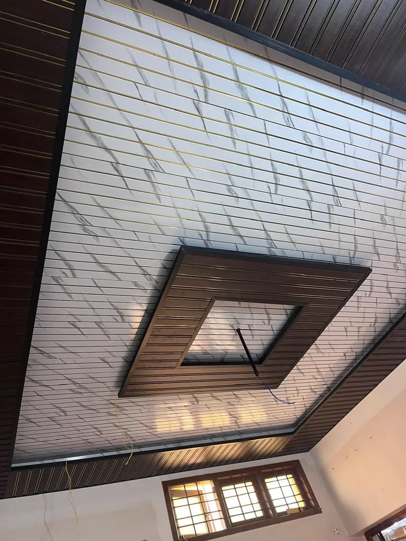 Marble-print PVC ceiling with a recessed timber-framed centre panel