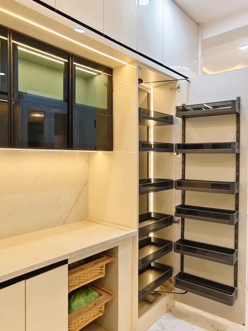 Tall pantry unit with pull-out larder baskets and profile lighting inside